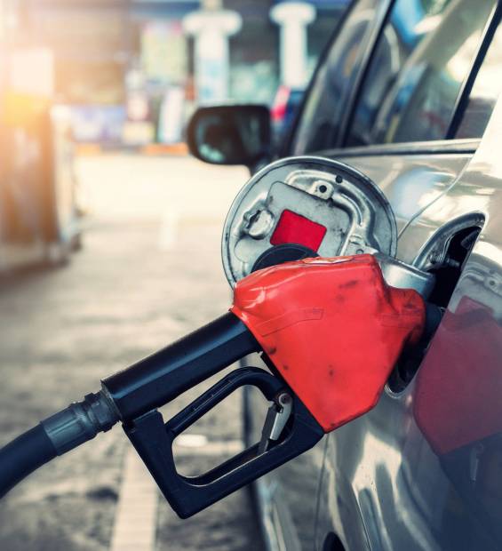 Pumping gasoline fuel in car at gas station Pumping gasoline fuel in car at gas station